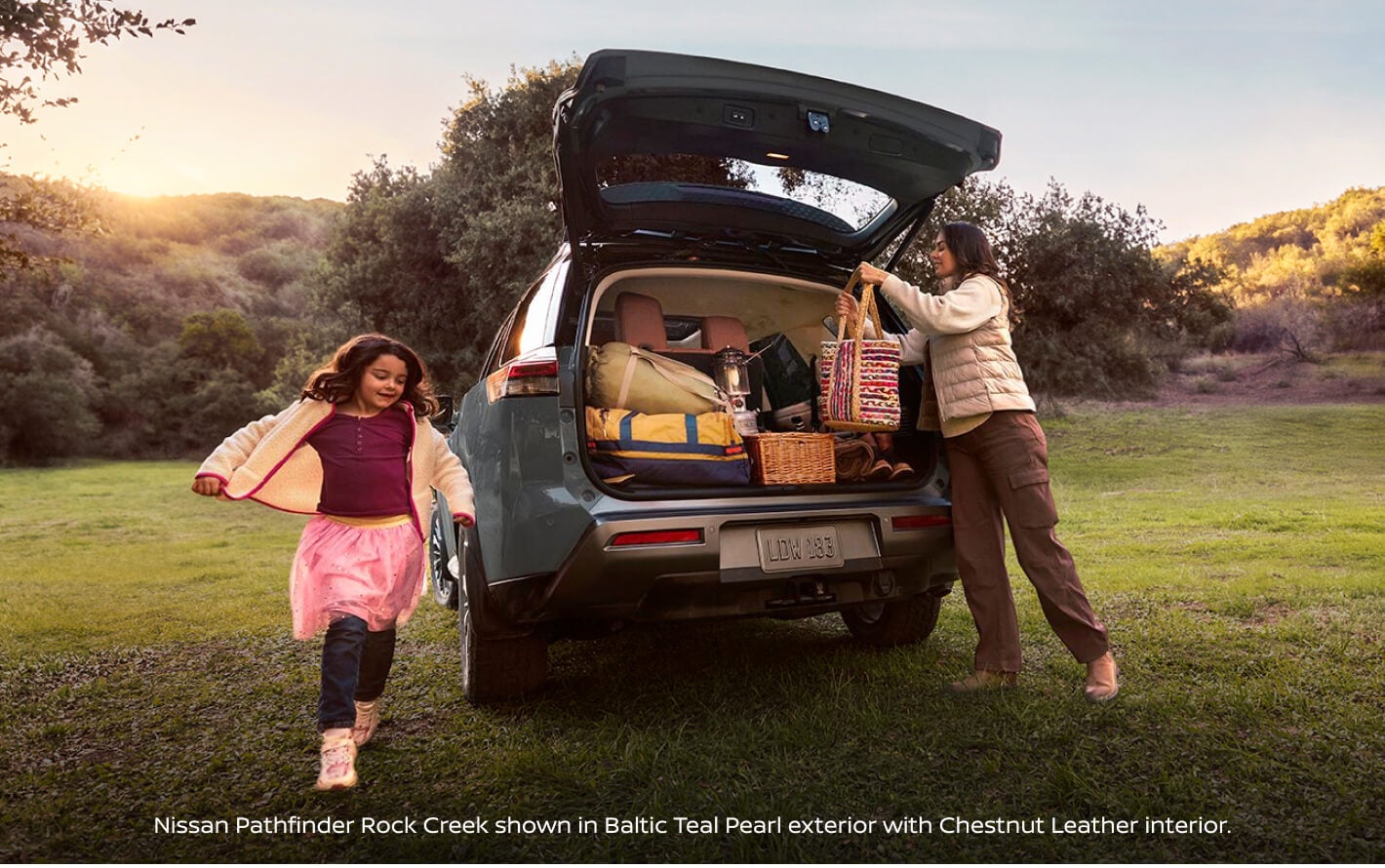 Rear view of a 2027 Nissan Pathfinder Rock Creek in Baltic Teal Pearl with Chestnut Leather interior.